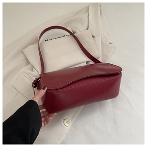 Dettaglio della borsa a spalla bordeaux in ecopelle opaca con patta e tracolla elegante