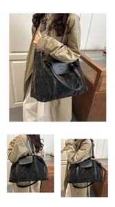 Detail of a black large capacity travel tote bag with textured waterproof fabric