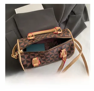Interior view of cylinder shoulder bag showing spacious storage for cosmetics and cards