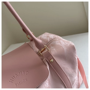 Detailed close-up of textured pink nylon fabric and brand logo on large tote bag