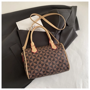 Detail of Boston bag showing geometric pattern, leather trim and detachable shoulder strap