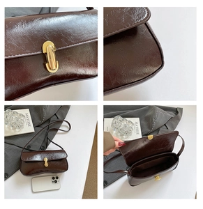 Detail of retro dark brown baguette bag featuring wrinkled texture and gold twist lock