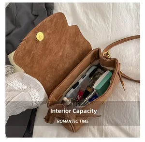 Detail of spacious interior compartment showing storage for phone and cosmetics