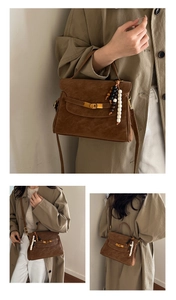 Detail of vintage brown frosted tote with wooden bead pendant and gold rotary lock