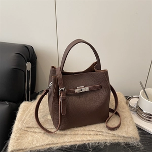 Elegant dark brown lychee leather bucket bag with silver metal lock and shoulder strap