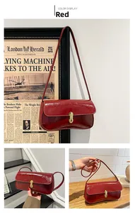 Macro view of dark red wax leather bag with golden twist lock and sleek shoulder strap