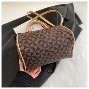 Detail of Boston barrel bag featuring geometric pattern and red edge finishing