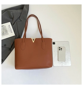 Brown lychee grain tote bag with gold V hardware, iPad and book for size reference