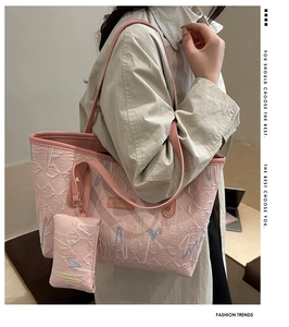 Detail of pink quilted tote bag set with heart embroidery and mini pouch attachment