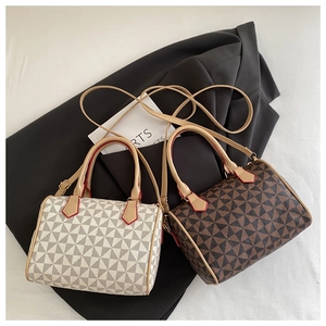 Detailed view of luxury Boston bags with geometric prints and red edge paint accents