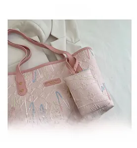 Detailed view of pink tote bag with colorful wave stitching and gold hardware accents