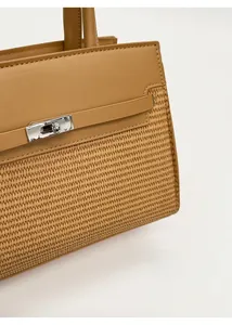 Detailed macro view of camel leather and woven material with silver metal twist lock