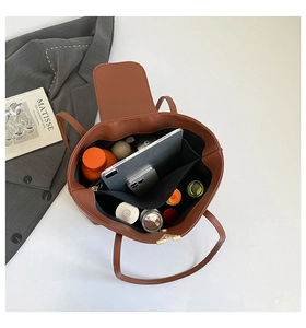 Interior view showing the large capacity and multiple pockets of this brown tote bag