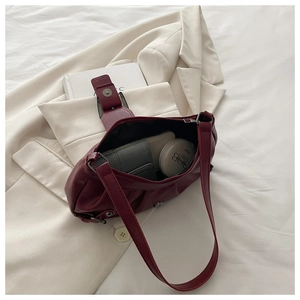 Interior view of wine red pleated shoulder bag showing spacious capacity for daily items