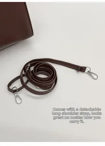 Detail of dark brown lychee grain leather detachable strap with silver swivel hooks