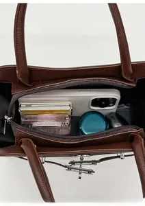 Spacious interior of dark brown litchi grain tote bag with zipper and essentials