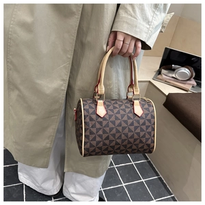 Classic Boston bag with geometric pattern, shown in a lifestyle commuter setting with a laptop
