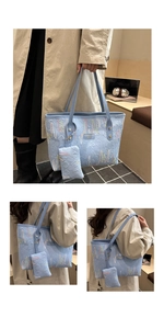 Detail of light blue embroidered tote bag with textured monogram and matching pouch