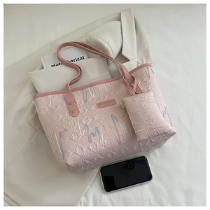 Close-up of pink tote bag with wavy embroidery and embossed texture for daily use