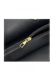 Detailed macro view of high-quality black lychee grain leather and smooth gold zipper