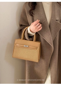 Close-up of minimalist retro tote bag featuring woven texture and brown leather accents