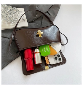 Detail view of brown vintage faux leather baguette bag showing spacious inner compartment