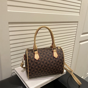 Boston-style crossbody bag with geometric pattern and top handles on white background