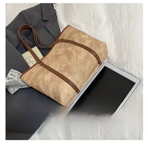 Detailed comparison of khaki tote bag size next to a tablet for business commute