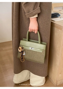 Detail of olive green patchwork handbag featuring woven texture and silver twist lock