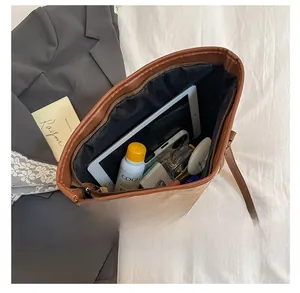 Top view of spacious interior of the tote bag with iPad and cosmetics inside