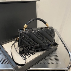 Fashionable black patent leather shoulder bag with embossed texture and gold hardware