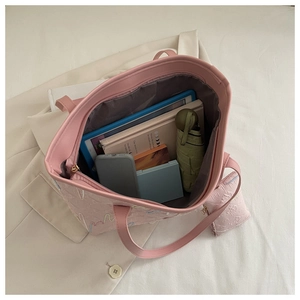 Spacious pink tote bag interior showing capacity for tablet, books, and umbrella