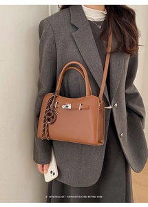 A minimalist sophisticated retro vibe brown leather crossbody bag with silver turn-lock