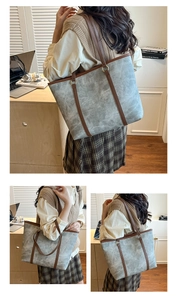 Detailed view of the large capacity tote bag with grey texture and brown straps