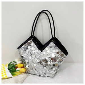 Detailed view of shimmering silver sequins on a V-shaped bucket bag with black leather trim