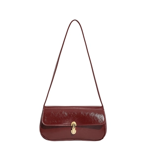 Deep red patent leather baguette bag with a gold metal clasp and thin shoulder strap