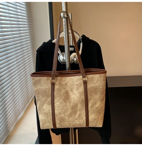 Macro shot of high-quality brown vintage tote bag with gold ring hardware and leather strap