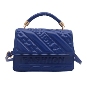 Royal blue glossy patent leather crossbody bag with embossed FASHION lettering detail