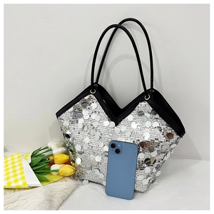 Detail of silver sequin tote bag with black strap and phone for size comparison