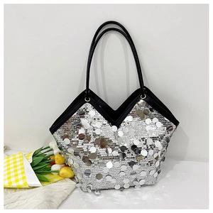 Detail of silver sequin tote bag with unique V-cut opening and elegant black handles
