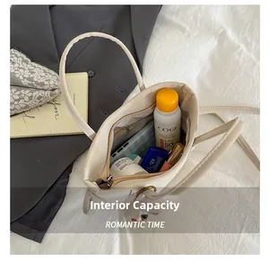 Detailed interior of minimalist off-white bucket bag showing large storage capacity