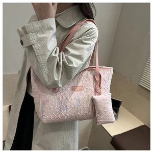 Detailed embroidery and letter pattern on pink tote bag with brand logo patch