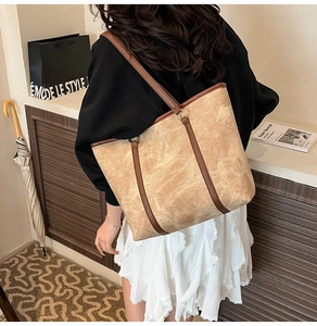 Close-up of vintage brown tote bag texture and premium leather handles detail