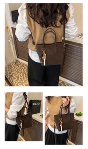Detail of a brown matte leather bucket bag with retro beaded charm and long strap