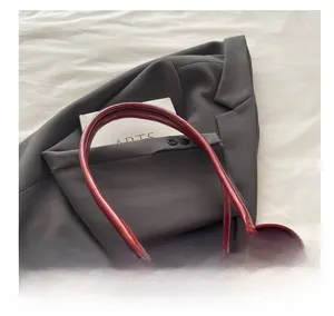 Detail of red velvet and leather vintage bowling bag with comfortable handles