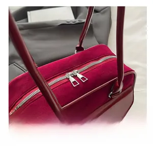 Detail of silver dual zippers on a vintage dark red velvet Boston shoulder bag for women
