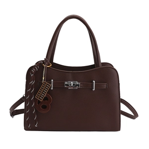 Dark brown leather handbag with silver turn-lock and decorative abacus charm on white background