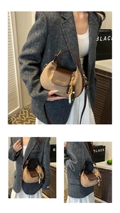 Detail of minimalist khaki canvas handbag with brown leather trim and colorful wood beads