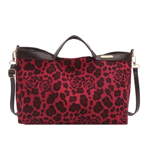 Leopard and rose print shoulder bag with brown leather handles and gold hardware accents