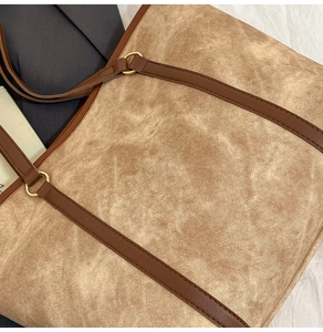 Close-up of the khaki twill fabric texture and brown leather strap with golden metal rings